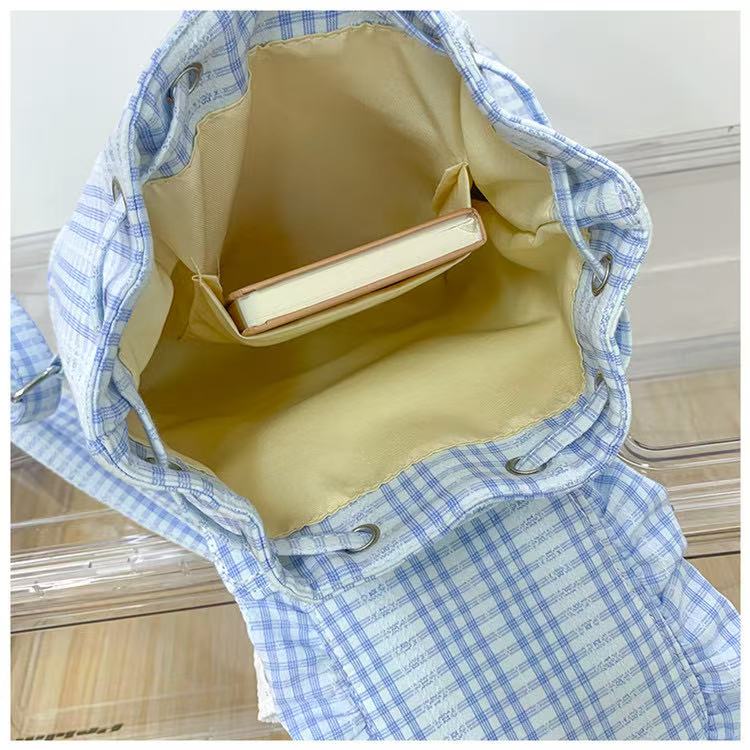 Small backpack with plaid flap